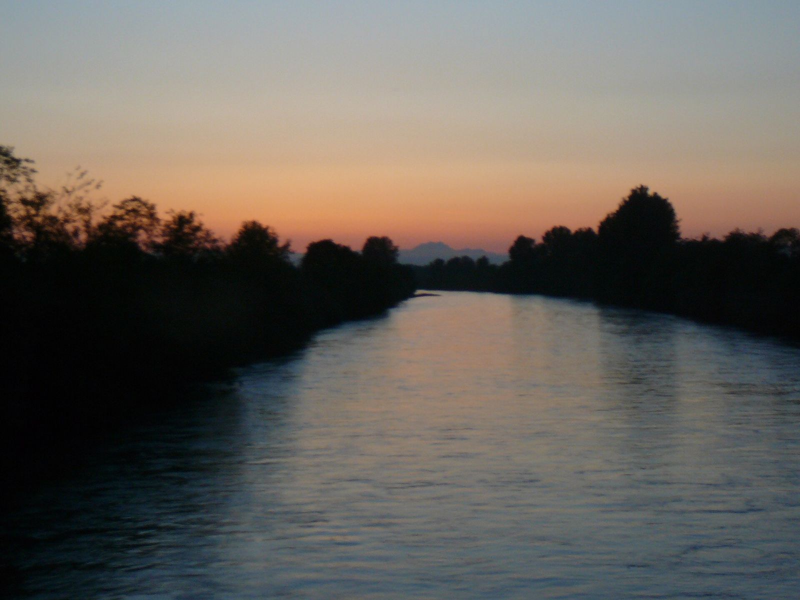 The Puyallup River at dusk with trees along the banks
