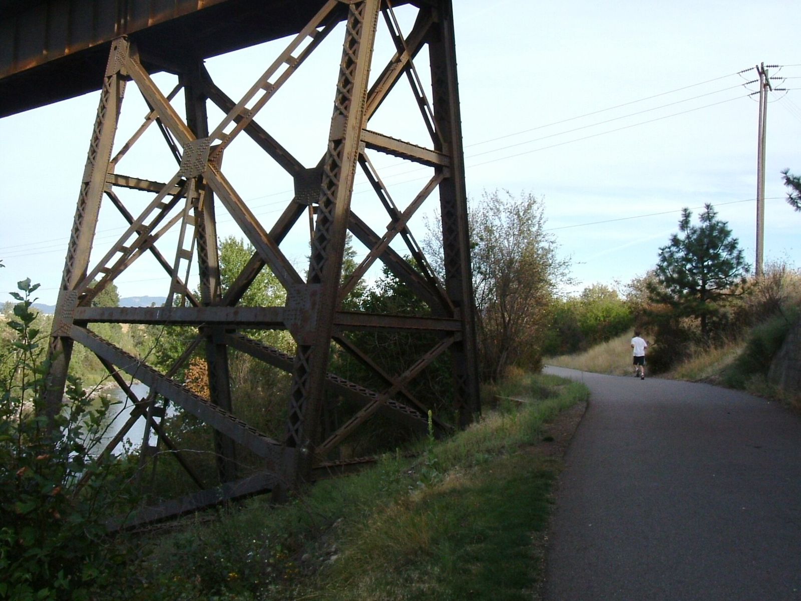 The Spokane River Centennial Trail passing under a railroad trestle